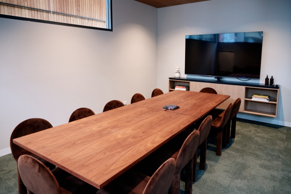 The Board Room, set with a long timber table and twelve upholstered chairs